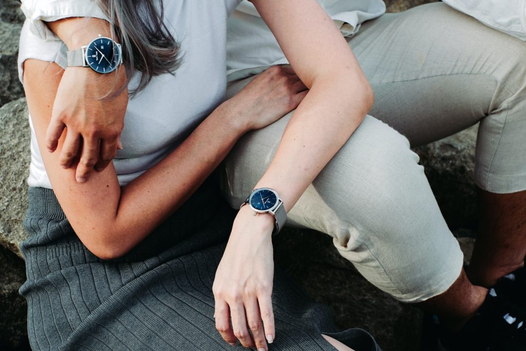 couple wearing silver-colored watch