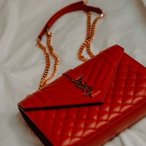 red leather flip case on white textile