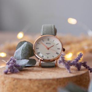 silver round analog watch on brown wooden table